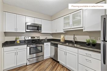 Kitchen, wood flooring available in select homes